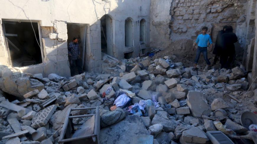 Residents inspect damage at a site hit by what activists said were airstrikes by forces loyal to Syria's president Bashar al-Assad in Aleppo, Syria December 25, 2015. REUTERS/Ammar Abdullah - RTX201R0