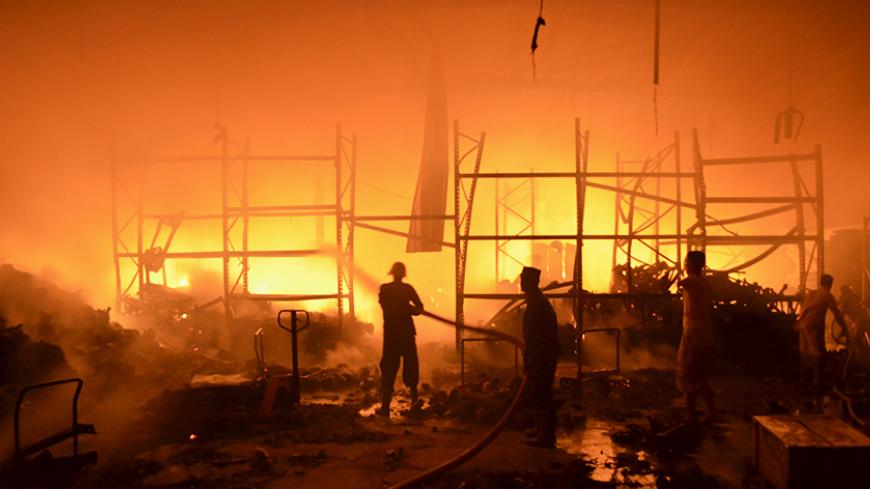 Firefighters attempt to extinguish a fire at a foodstuff storage facility destroyed by a Saudi-led air strike in Yemen's Red Sea port city of Houdieda January 6, 2016. REUTERS/Abduljabbar Zeyad - RTX2177D