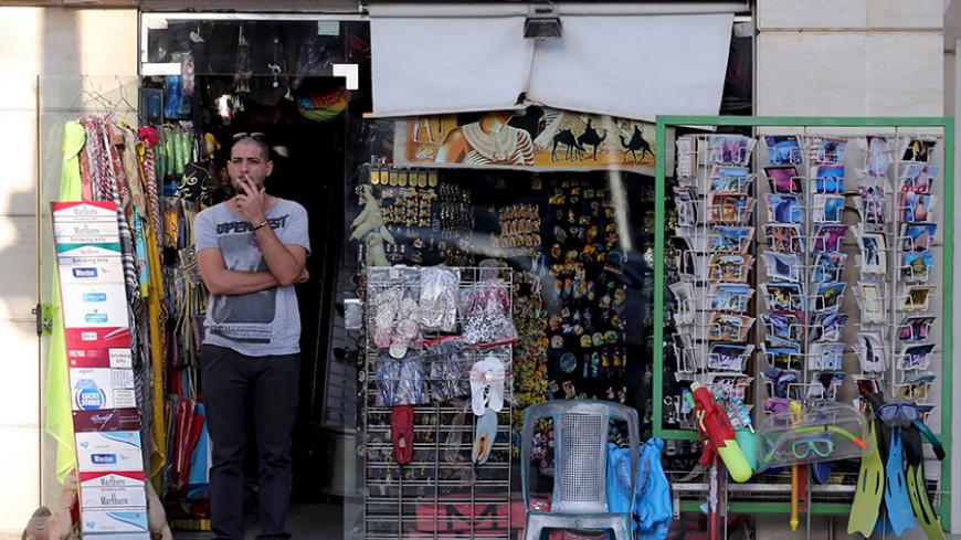 A shopkeeper waits for tourists at a souvenir shop in the Red Sea resort of Hurghada, Egypt, January 9, 2016. Two armed assailants attacked the hotel in the Egyptian Red Sea resort town of Hurghada on Friday, wounding three foreign tourists, Egyptian officials said. REUTERS/Mohamed Abd El Ghany - RTX21N1S