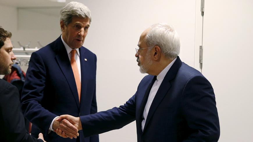 U.S. Secretary of State John Kerry shakes hands with Iranian Foreign Minister Mohammad Javad Zarif after the International Atomic Energy Agency (IAEA) verified that Iran has met all conditions under the nuclear deal, in Vienna January 16, 2016. REUTERS/Kevin Lamarque TPX IMAGES OF THE DAY - RTX22P8Q