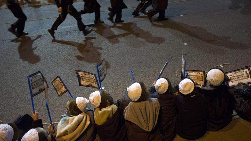 Ultra-Orthodox Jewish boys hold flags during a rally organised to welcome Rabbi Zalman Leib Teitelbaum, in Jerusalem's Mea Shearim neighbourhood January 20, 2013. Local media said that Rabbi Zalman Leib Teitelbaum, son of the late Rabbi Moses Teitelbaum, leader of the Satmar Hasidim landed in Israel on Sunday for the wedding of his granddaughter which will take place later in the week. REUTERS/Ronen Zvulun (JERUSALEM - Tags: RELIGION) - RTR3CPHG