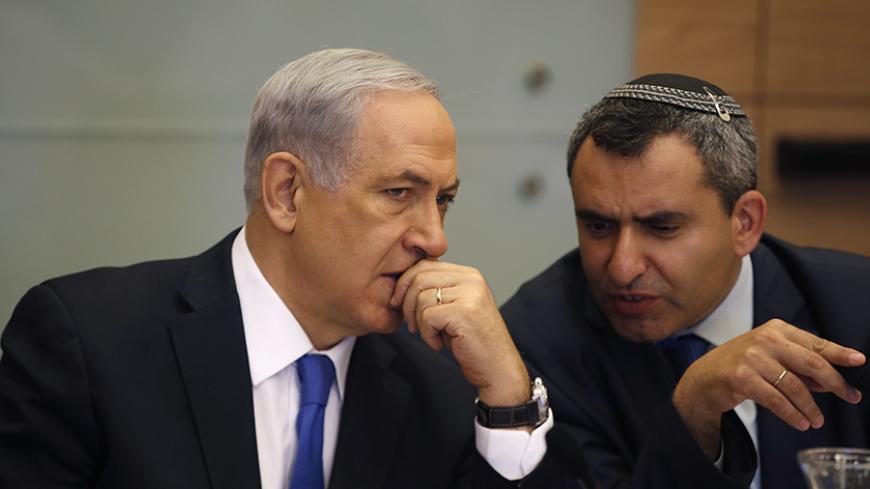 Israel's Prime Minister Benjamin Netanyahu (L) listens to Foreign Affairs and Defence committee chair Zeev Elkin during a committee meeting at parliament in Jerusalem June 2, 2014. Netanyahu warned on Sunday against any international rush to recognise a Palestinian government due to be announced under a unity pact between the Fatah and Hamas Islamist groups.REUTERS/Ronen Zvulun (JERUSALEM - Tags: POLITICS) - RTR3RRU6
