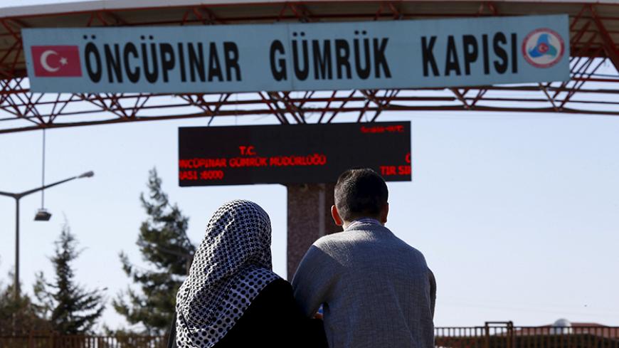 Two Syrians wait on the Turkish side of the Oncupinar border crossing for their parents to arrive from Syria, on the Turkish-Syrian border in the southeastern city of Kilis, Turkey, February 8, 2016. REUTERS/Osman Orsal TPX IMAGES OF THE DAY - RTX25Y24