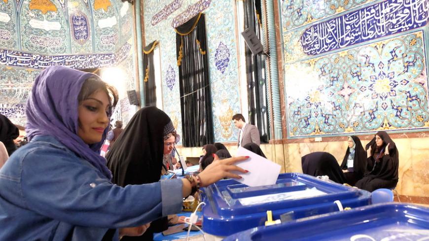 An Iranian woman casts her ballot during elections for the parliament and Assembly of Experts, which has the power to appoint and dismiss the supreme leader, in Tehran February 26, 2016. REUTERS/Raheb Homavandi/TIMA ATTENTION EDITORS - THIS IMAGE WAS PROVIDED BY A THIRD PARTY. FOR EDITORIAL USE ONLY. - RTX28NR6