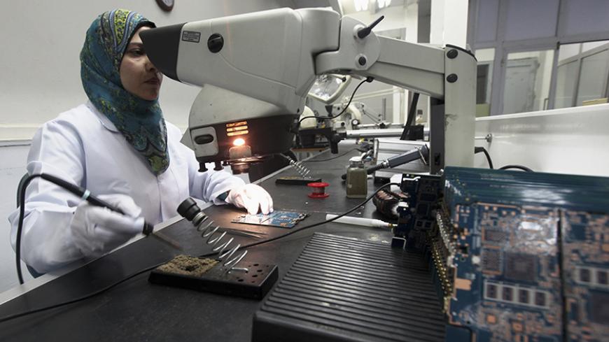 A worker checks Egypt's first tablet computer "Inar" in Benha May 18, 2013. Egypt has produced its very first tablet computer "Inar", part of a national project to distribute the device to students in schools and universities around the country. The Ministry of Military Production in collaboration with the Ministry of Communications presented the scheme last year to Benha Electronics Company known as 'Katron' to manufacture the tablet. Picture taken May 18, 2013. REUTERS/Mohamed Abd El Ghany (EGYPT - Tag
