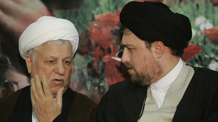 Former Iranian President Akbar Hashemi Rafsanjani (L) speaks with the late Ayatollah Ruhollah Khomeini's grandson, Hassan Khomeini, during the anniversary ceremony of Iran's Islamic revolution at the Khomeini shrine in the Behesht Zahra cemetery, south of Tehran, February 1, 2007. REUTERS/Raheb Homavandi (IRAN) - RTR1LV47