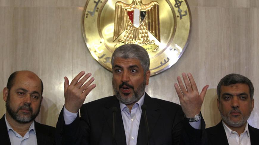 Hamas leader Khaled Meshaal (C) speaks during a news conference with Hamas delegates after their meeting with Egypt's President Mohamed Mursi at the presidential palace in Cairo July 19, 2012. REUTERS/Amr Abdallah Dalsh (EGYPT - Tags: POLITICS) - RTR352XW