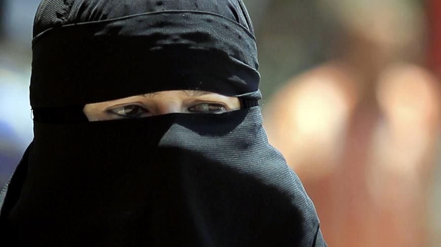 An Egyptian woman wearing nijab walks in Cairo July 19, 2012. In an age of new freedoms in the post-Hosni Mubarak Egypt, niqab-wearing women long oppressed socially and politically are hoping for a new place in society. Though Egypt is a deeply conservative and predominantly Muslim society, niqab wearers have cited discrimination in the job market, education and elsewhere. A new TV channel being managed and run exclusively by women who wear the full veil, to be launched this weekend on the first day of the 