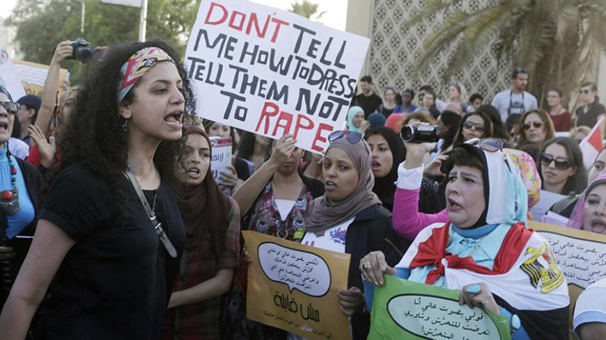 Women chant slogans as they gather to protest against sexual harassment in front of the opera house in Cairo June 14, 2014, after a woman was sexually assaulted by a mob during the June 8 celebrations marking the new president Abdel Fattah al-Sisi's inauguration in Tahrir square. Egypt has asked YouTube to remove a video showing the naked woman with injuries being dragged through the square after being sexually assaulted during the celebrations. Authorities have arrested seven men aged between 15 and 49 for