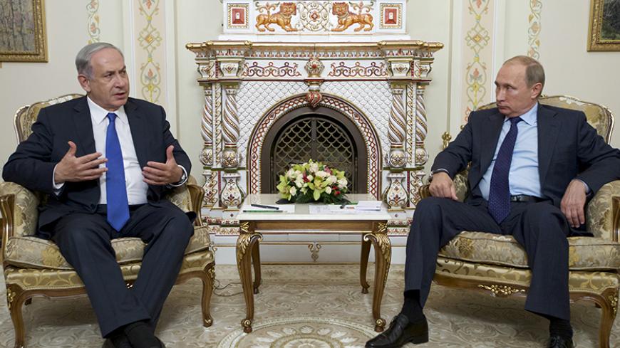 Israeli Prime Minister Benjamin Netanyahu (L) speaks with Russian President Vladimir Putin during their meeting at the Novo-Ogaryovo state residence outside Moscow, Russia, September 21, 2015. Netanyahu said his visit to Moscow on Monday was aimed at preventing clashes between Russian and Israeli military forces in the Middle East. REUTERS/Ivan Sekretarev/Pool - RTS25BW