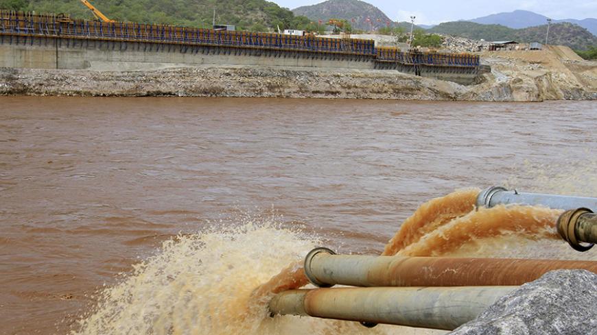 Water gushes out from pipes by the construction of Ethiopia's Great Renaissance Dam in Guba Woreda, some 40 km (25 miles) from Ethiopia's border with Sudan, June 28, 2013. Egypt fears the $4.7 billion dam, that the Horn of Africa nation is building on the Nile, will reduce a water supply vital for its 84 million people, who mostly live in the Nile valley and delta. Picture taken June 28, 2013. REUTERS/Tiksa Negeri (ETHIOPIA - Tags: POLITICS SOCIETY ENERGY ENVIRONMENT) - RTX115KE