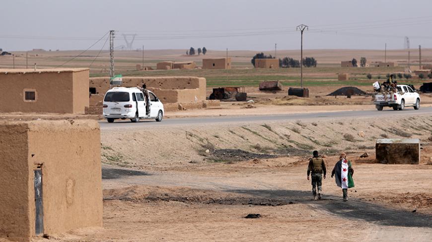 Free Syrian Army fighters walk in al-Makman village on the outskirts of al-Shadadi town, Hasaka countryside, Syria February 19, 2016. REUTERS/Rodi Said  - RTX27SJH