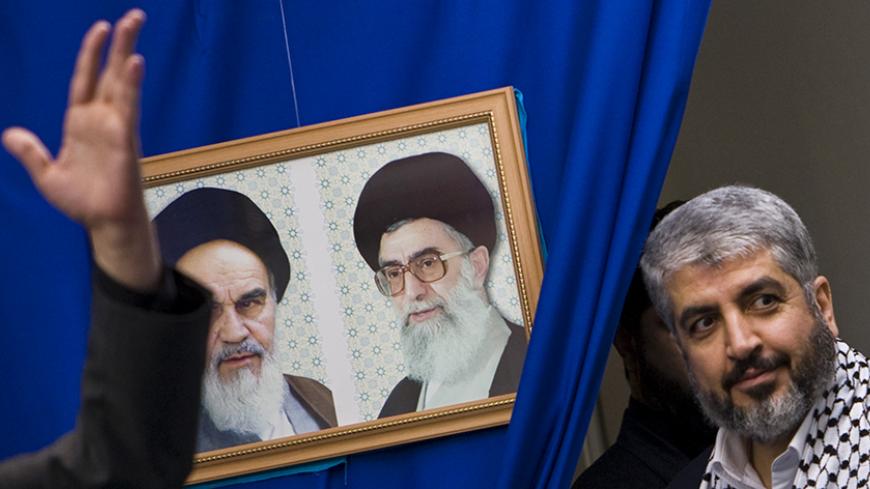 Hamas leader Khaled Meshaal (R) attends a rally in Tehran university February 2, 2009. A delegation from Hamas, headed by its leader Meshaal, arrived in Tehran on Sunday as part of a regional push to reinforce support for the Palestinian group after the Israeli invasion of Gaza. The portraits on the left are that of Late Leader Ayatollah Rouollah Khomeini (L) and Iran's Supreme Leader Ayatollah Ali Khamenei. REUTERS/Raheb Homavandi (IRAN) - RTXB5LP