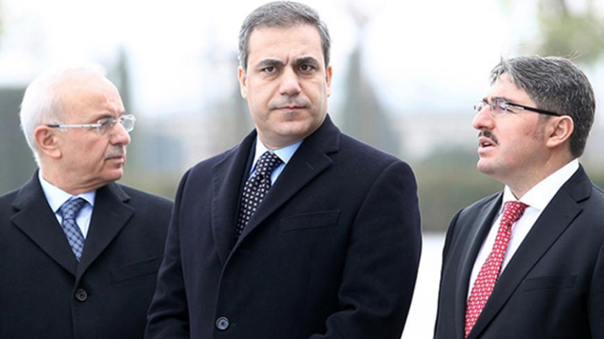This file picture taken on December 19, 2014 shows the head of Turkey's intelligence agency Hakan Fidan (C) standing in Ankara. The powerful head of Turkey's intelligence agency, one of the most loyal allies of President Recep Tayyip Erdogan, has resigned to stand for election as a lawmaker, the official Anatolia news agency said on February 7, 2015. The resignation of Hakan Fidan, who has headed the National Intelligence Agency (MIT) since 2010, has been accepted by Prime Minister Ahmet Davutoglu and will