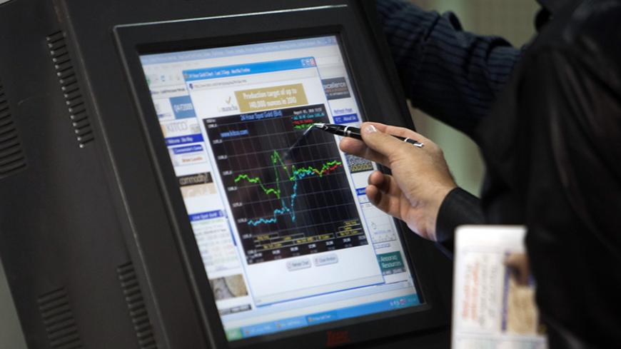 EDITORS' NOTE:  Reuters and other foreign media are subject to Iranian restrictions on their ability to film or take pictures in Tehran.

An Iranian investor checks stock information on a screen at the Tehran Stock Exchange August 3, 2010. Sanctions against Iran have done nothing to dent a boom in its stock market, as investors bet on a continued rise in company stocks which have been undervalued for years, the head of the Tehran bourse said.   REUTERS/Morteza Nikoubazl (IRAN - Tags: BUSINESS POLITICS) - RT
