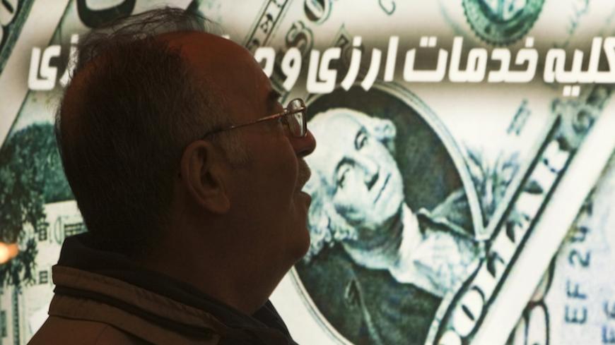 EDITORS' NOTE: Reuters and other foreign media are subject to Iranian restrictions on leaving the office to report, film or take pictures in Tehran.

An Iranian man walks past a currency exchange shop in northern Tehran January 3, 2012. The Iranian rial fell to a record low against the dollar on Tuesday following U.S. President Barack Obama signing a bill on  imposing fresh sanctions against the country's central bank.   REUTERS/Morteza Nikoubazl (IRAN - Tags: BUSINESS POLITICS) - RTR2VU6Z