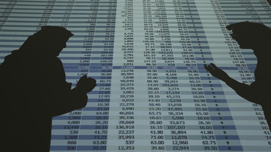 The shadows of investors and speculators are seen cast on a screen as they monitor stock prices at the FALCOM investment bank in Riyadh August 5, 2014. Saudi Arabia is one of the last major markets in the world to open up, so the reform is attracting massive interest among international fund managers. But they will face an unusual and in some ways difficult trading environment. Picture taken August 5, 2014.  REUTERS/Faisal Al Nasser (SAUDI ARABIA - Tags: BUSINESS) - RTR42ECU