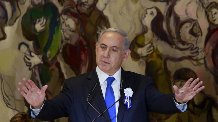Israel's Prime Minister Benjamin Netanyahu gestures as he speaks at an event following the swearing-in ceremony of the 20th Knesset, the new Israeli parliament, in Jerusalem March 31, 2015. Netanyahu said on Tuesday the framework Iranian nuclear agreement being sought by international negotiators will leave Iran with the capability to develop a nuclear weapon in under a year. REUTERS/Gali Tibbon/Pool - RTR4VMVY