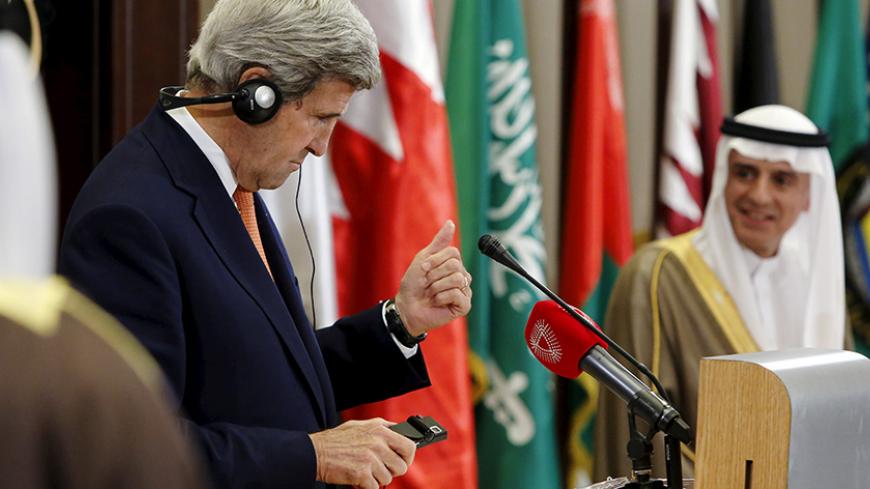 U.S. Secretary of State John Kerry gives a thumbs-up to Saudi Arabia's Foreign Minister Adel al-Jubeir after a check of his translation headset before their remarks to reporters alongside the Gulf Cooperation Council (GCC) ministerial meeting in Manama, Bahrain April 7, 2016. REUTERS/Jonathan Ernst TPX IMAGES OF THE DAY - RTSE25F