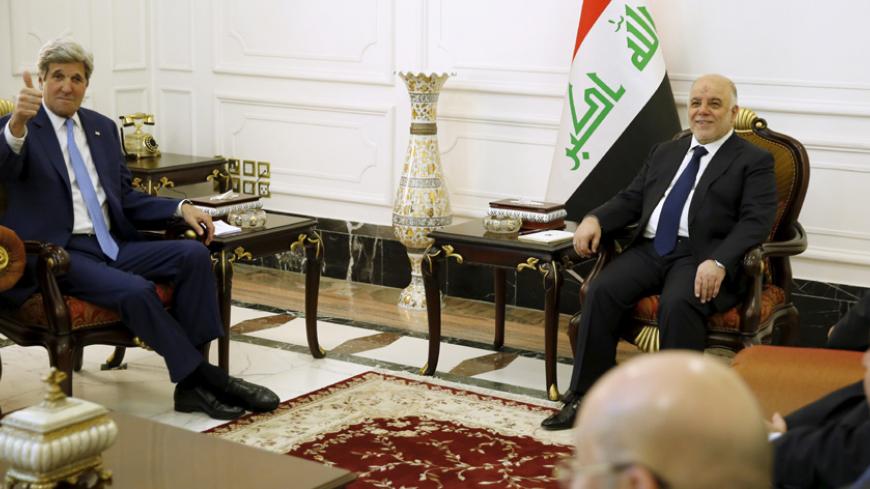 U.S. Secretary of State John Kerry (L) gives a thumbs-up as Iraq's Prime Minister Haider al-Abadi (R) welcomes him at the prime minister's palace in Baghdad April 8, 2016. REUTERS/Jonathan Ernst - RTSE5GF