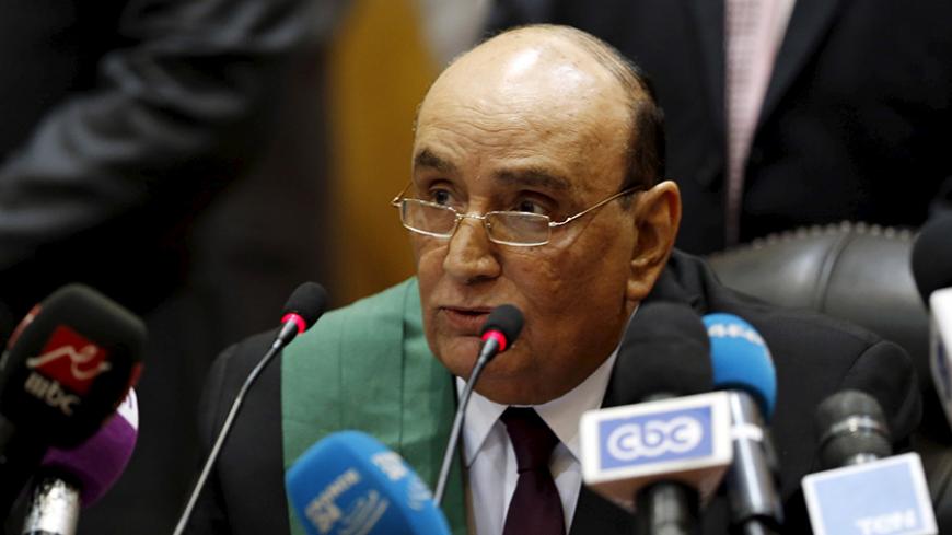 Judge Ahmed Sabry Youssef speaks during the trial of ousted Egyptian President Mohamed Mursi and Muslim brotherhood leaders at a court in the outskirts of Cairo, April 21, 2015. An Egyptian court has sentenced ousted Islamist president, Mohamed Mursi, to 20 years in jail on charges of inciting the killing of protesters in Cairo in December 2012.REUTERS/Amr Abdallah Dalsh - RTX19M68