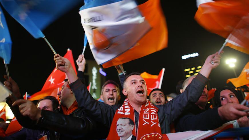 People wave flags outside the AK Party headquarters in Ankara, Turkey November 1, 2015. Turks went to the polls in a snap parliamentary election on Sunday under the shadow of mounting internal bloodshed and economic worries, a vote that could determine the trajectory of the polarised country and of President Tayyip Erdogan. The vote is the second in five months, after the AK Party founded by Erdogan lost in June the single-party governing majority it has enjoyed since first coming to power in 2002.   REUTER