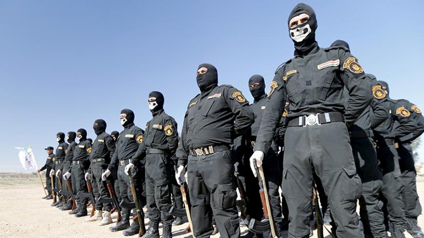 Iraqi Sunni Muslim fighters from Hashid Shaabi (Popular Mobilization) take part in a parade during a ceremony marking the Iraqi Police Day at Amiriyat al-Fallujah in Anbar province, January 9, 2016. REUTERS/Thaier Al-Sudani - RTX21NI3