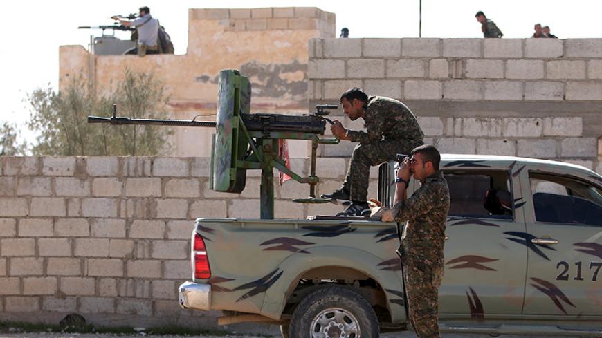 Syria Democratic Forces fighters look through a scope and a pair of binoculars on the outskirts of al-Shadadi town, in 47 village, Hasaka countryside, Syria February 19, 2016. Picture taken February 19, 2016. REUTERS/Rodi Said       TPX IMAGES OF THE DAY      - RTX27SHA