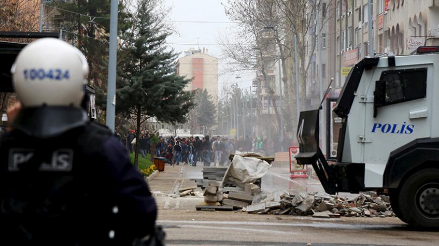 Kurdish demonstrators gather behind a barricade as they clash with Turkish riot police during a protest against the curfew in Sur district, in the southeastern city of Diyarbakir, Turkey, February 21, 2016. REUTERS/Sertac Kayar - RTX27Y46