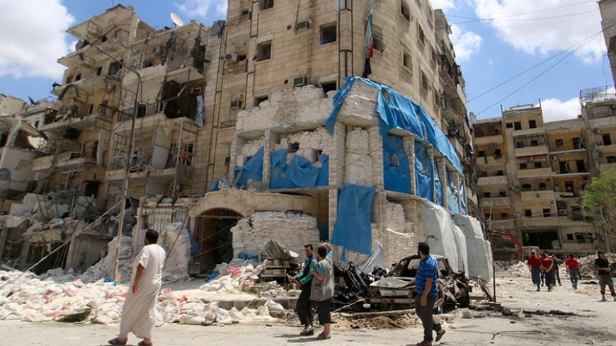 People inspect the damage at al-Quds hospital after it was hit by airstrikes, in a rebel-held area of Syria's Aleppo, April 28, 2016. REUTERS/Abdalrhman Ismail     TPX IMAGES OF THE DAY      - RTX2C10D