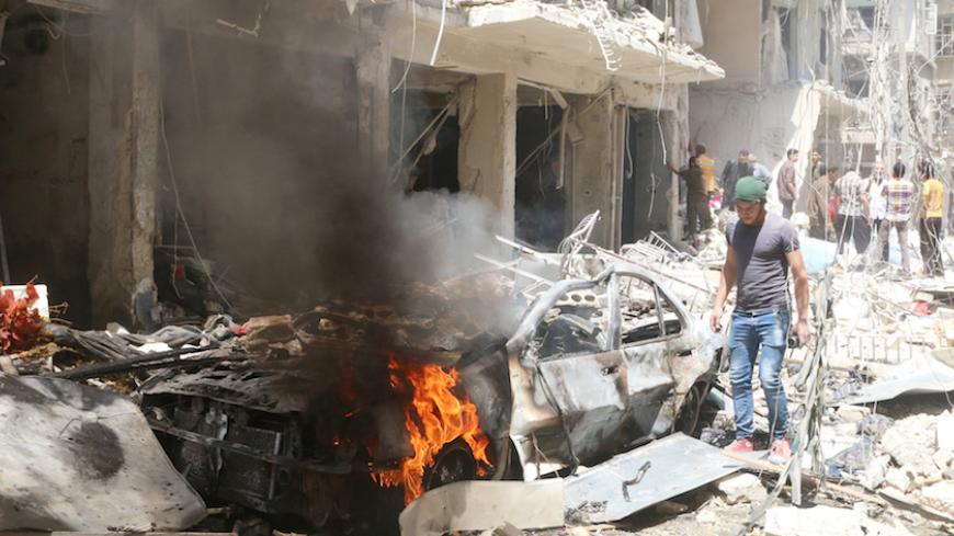 People inspect the damage at a site hit by airstrikes, in the rebel-held area of Aleppo's Bustan al-Qasr, Syria April 28, 2016. REUTERS/Abdalrhman Ismail - RTX2C1BK
