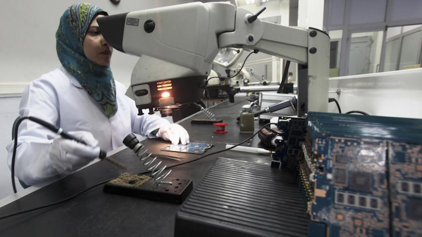 A worker checks Egypt's first tablet computer "Inar" in Benha May 18, 2013. Egypt has produced its very first tablet computer "Inar", part of a national project to distribute the device to students in schools and universities around the country. The Ministry of Military Production in collaboration with the Ministry of Communications presented the scheme last year to Benha Electronics Company known as 'Katron' to manufacture the tablet. Picture taken May 18, 2013.    REUTERS/Mohamed Abd El Ghany (EGYPT - Tag