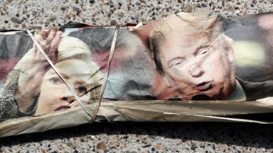 A rubber band wraps the front page of the La Opinion newspaper featuring pictures of Democratic Presidential Candidate Hillary Clinton and Republican Presidential Candidate Donald Trump as the newspaper lies on the sidewalk ahead of the California Primary election in Santa Ana, California May 15, 2016. Picture taken May 15, 2016.  REUTERS/Patrick T. Fallon - RTSEKH5