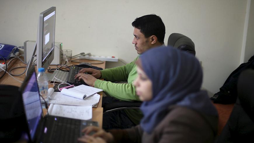 Young Palestinian entrepreneurs use their computers at Gaza Sky Geeks office, in Gaza City January 18, 2016. Picture taken January 18, 2016. REUTERS/Ibraheem Abu Mustafa - RTX242SL