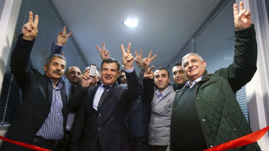 Participants pose for a picture during a ceremony opening a representative office of Syrian Kurdistan in Moscow, Russia, February 10, 2016. Syrian Kurdistan is also known as Western Kurdistan or Rojava region - the term commonly used by Kurds living in Syria. REUTERS/Maxim Shemetov  - RTX26BWH