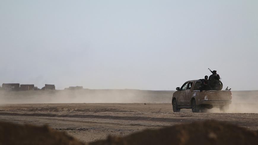 Fighters from the Democratic Forces of Syria drive to position themselves in Ghazila village after taking control of the town from Islamic State forces in the southern countryside of Hasaka, Syria February 17, 2016. Picture taken February 17, 2016. REUTERS/Rodi Said  - RTX27JLU