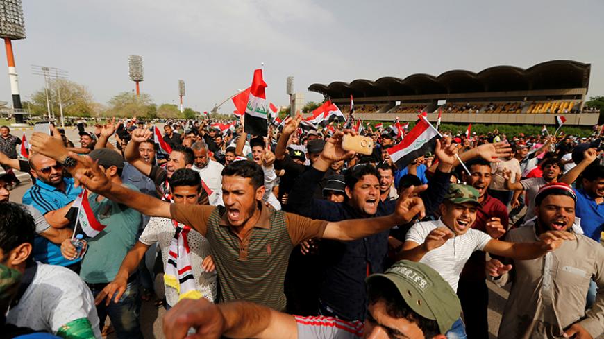 Followers of Iraq's Shi'ite cleric Moqtada al-Sadr shout slogans at Grand Festivities Square within the Green Zone in Baghdad, Iraq, May 1, 2016. REUTERS/Thaier Al-Sudani - RTX2CCQK