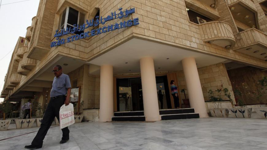 A man leaves the Iraq Stock Exchange (ISX) in Baghdad, April 2, 2013. Last month's scene at the headquarters of the Baghdad bourse revealed the struggle which Iraq faces to modernise its financial system: it must overcome primitive, ultra-conservative savings habits born of decades of war and political instability. Picture taken April 2, 2013.  REUTERS/Mohammed Ameen (IRAQ - Tags: BUSINESS) - RTXY6V0