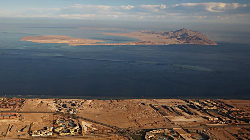(FILE) A picture taken on January 14, 2014 through the window of an airplane shows the Red Sea's Tiran (foreground) and the Sanafir (background) islands in the Strait of Tiran between Egypt's Sinai Peninsula and Saudi Arabia.
Saudi King Salman on April 11, 2016 wrapped up a landmark five-day visit to Egypt marked by lavish praise and multi-billion-dollar investment deals, in a clear sign of support for President Abdel Fattah al-Sisi's regime. Egypt also agreed during the visit to demarcate its maritime bord
