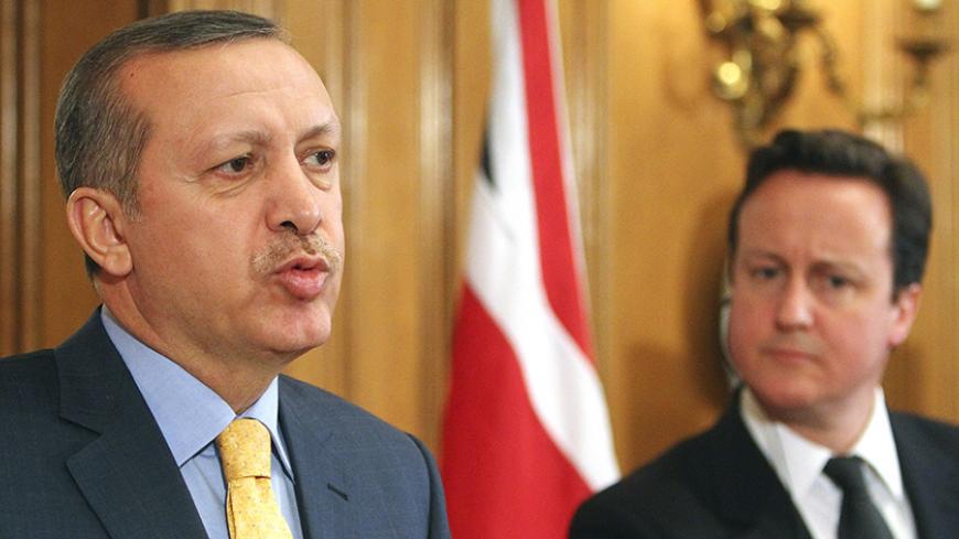 Britain's Prime Minister David Cameron (R) listens, as his Turkish counterpart Recep Tayyip Erdogan speaks, during a news conference at number 10 Downing Street in London March 31, 2011.   REUTERS/Geoff Caddick/pool (POLITICS) - RTR2KNNG