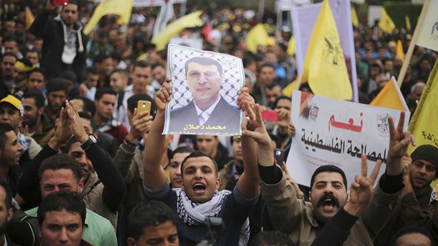 A Palestinian supporter of former head of Fatah in Gaza, Mohammed Dahlan, holds a poster depicting Dahlan during a protest against Palestinian President Mahmoud Abbas in Gaza City December 18, 2014. Dahlan, who lives in exile in the Gulf, is a powerful political foe of Abbas.
REUTERS/Mohammed Salem (GAZA - Tags: POLITICS CIVIL UNREST) - RTR4IJ8R