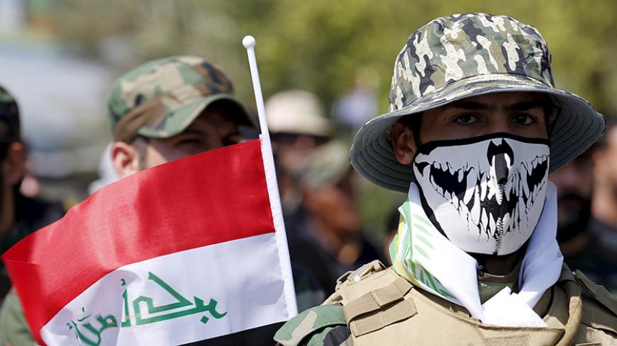 Iraqi Shiite Muslim men from Hashid Shaabi (Popular Mobilization) march during a parade marking the annual al-Quds Day, or Jerusalem Day, on the last Friday of the Muslim holy month of Ramadan in Baghdad, July 10, 2015. REUTERS/Thaier al-Sudani - RTX1JVPP