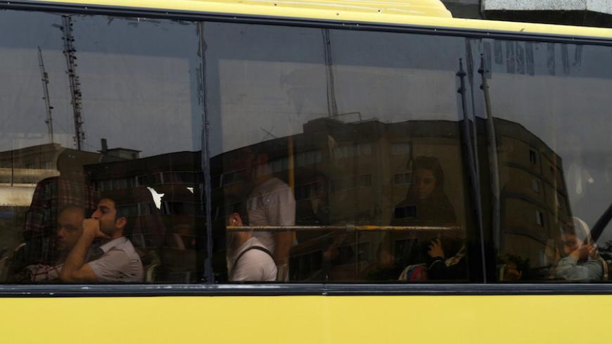 Commuters ride in a bus during evening rush hour in Tehran, Iran May 2, 2016. REUTERS/Marius Bosch   - RTX2CGB9