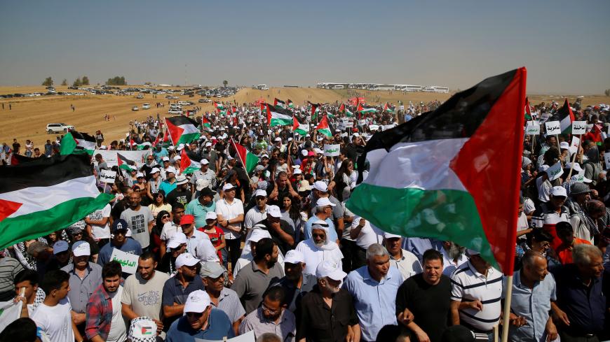 Israeli Arabs and other supporters wave Palestinian flags as they march during a protest to mark the right of return for refugees who fled their homes during the 1948 ArabÐIsraeli War, at a village near Rahat in southern Israel, May 12, 2016. The 1948 war followed the creation of Israel, which marks its 68th Independence Day this year. REUTERS/Ammar Awad - RTX2E17F