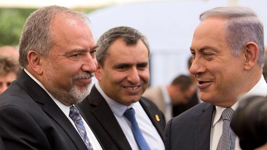 Israeli Prime Minister Benjamin Netanyahu (R) and Israel's defense minister, Avigdor Lieberman (L) during a special Cabinet meeting to mark Jerusalem Day in Ein Lavan Spring located in the outskirts of Jerusalem 02 June 2016. REUTERS/Abir Sultan/Pool - RTX2FAFI