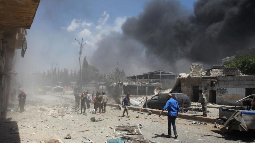People inspect a site hit by airstrikes in Idlib city, Syria June 12, 2016. REUTERS/Ammar Abdullah - RTX2FR1Q