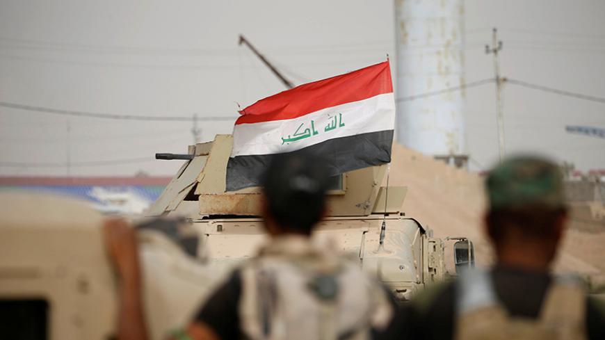 Members of the Iraqi army gather in central Falluja, Iraq, June 18, 2016. REUTERS/Thaier Al-Sudani - RTX2GXW3
