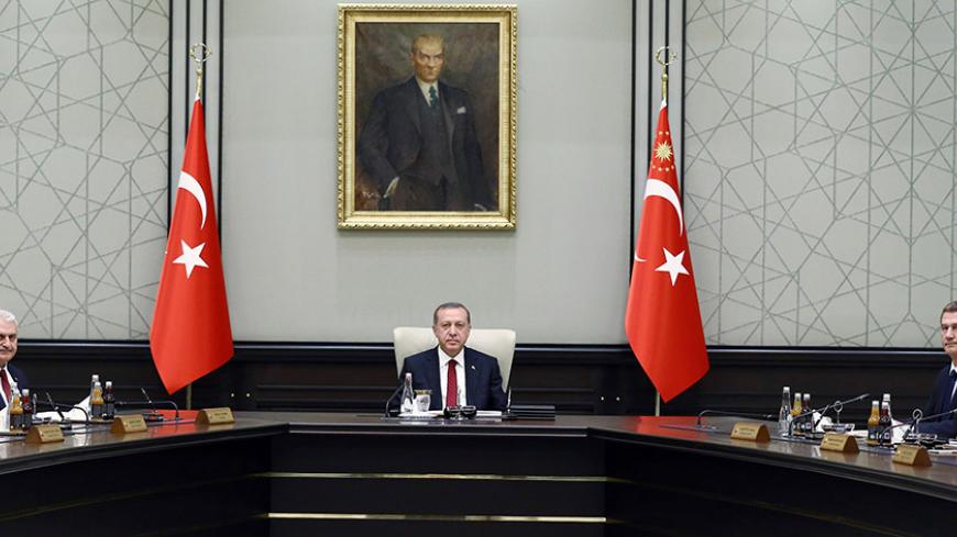 President of Turkey Recep Tayyip Erdogan (C) chairs the meeting of 65th Cabinet of Turkey at Presidential Complex, in Ankara on May 25, 2016. / AFP / KAYHAN OZER (Photo credit should read KAYHAN OZER/AFP/Getty Images)