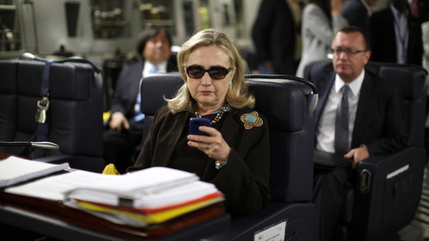 U.S. Secretary of State Hillary Clinton checks her PDA upon her departure in a military C-17 plane from Malta bound for Tripoli,  Libya October 18, 2011. 
REUTERS/Kevin Lamarque  (LIBYA - Tags: POLITICS)         FOR BEST QUALITY IMAGE ALSO SEE: GF2EA1P10ZY01 - RTR2ST4W