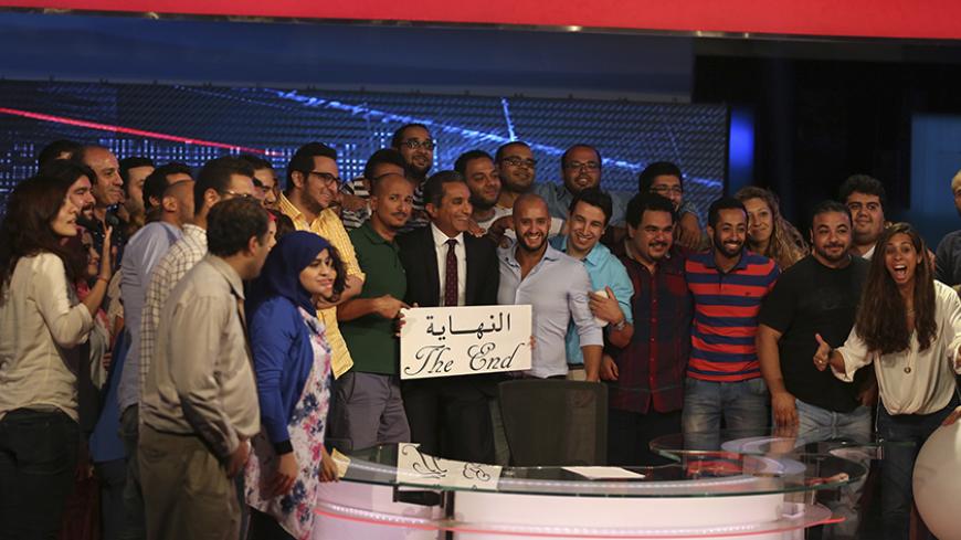 Egyptian satirist Bassem Youssef (C) poses for a photo with the crew of his show 'al-Bernameg' after announcing its cancellation in Cairo June 2, 2014. Egypt's top TV satirist said on Monday his show had been canceled, amid speculation it was because his latest script poked fun at a presidential election won by the former army chief.Bassem Youssef, known as the "Egyptian Jon Stewart", told a news conference the Saudi-owned MBC Masr TV station had been put under more pressure "than it could handle".REUTERS/M